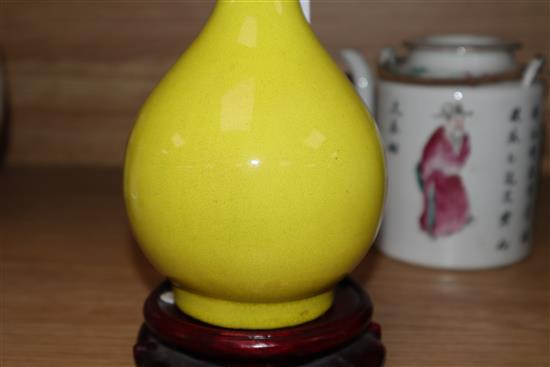 A Chinese famille rose teapot, a yellow glazed bottle vase, and a celadon glazed teapot vase 17cm incl. stand